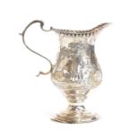 A small George III silver milk jug, London 1778, chased with swan, millpond, cow and cottages, 10.