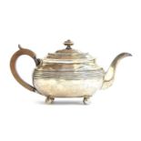 A George III silver teapot by Solomon Hougham, London 1809, of banded oblong form, on ball feet,