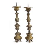 A pair of 18th century Italian brass pricket candlesticks, with knopped stems and triform bases,