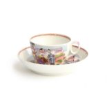 A New Hall teacup and saucer, in a rare 1172 pattern Mandarin family scene, c.1820, New Hall mark to