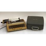 A Smith-Corona model C420 electric type writer; together with an Erica portable typewriter (locked)