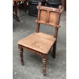 A Gothic oak hall chair, on turned legs