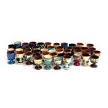 A large collection of approx. 50 Torquay mottoware eggcups, to include Longpark and Widecombe
