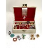 A quantity of costume jewellery in a musical jewellery box to include Ciro brooch and matching