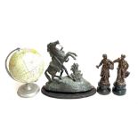 A spelter Marley horse; a pair of spelter figures, 'La Bouquetiere' and 'Le Colporteur'; and a globe