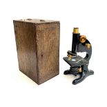 An R & J Beck microscope, in oak case