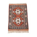 A rug in Kazak style, approx 180x114cm; together with a small machine woven prayer rug (2)
