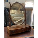 An adjustable oval box mirror with three drawers and central shell patera, 47cmW