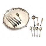 A set of four silver teaspoon with engraved handles; together with a silver sugar sifter, teaspoon