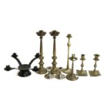 A quantity of brass candlesticks, the tallest pair 33cmH; together with a quantity of model wrought
