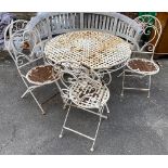 A fixed white painted metal garden table; together with three folding chairs