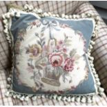 A needlework cushion with floral design