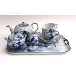 A Delft blue and white tea service, comprising teapot, cups, saucers, tray etc