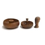 Two turned wooden nut bowls, one with band of inlay, 18 and 23cmD; together with a hardwood carved