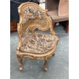 A 20th century gilt gesso caned and needlework corner chair, in Rococo style, 70cmW