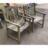 A pair of slatted teak garden armchairs, 62cmW