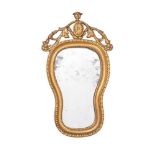 An early 19th century giltwood wall mirror, scrollwork and moulded slip around hourglass shaped