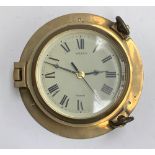 A Nauticalia Saloon brass ships porthole clock, the dial with Roman numerals, bevelled glass, 23cmD