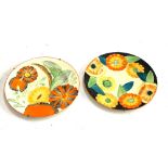 A pair of Grays Pottery hand painted art deco wall plates, each 27cmD; together with a ruby glass