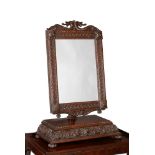A large Victorian carved oak dressing mirror, the crest carved with conjoined serpents, 65cm wide,