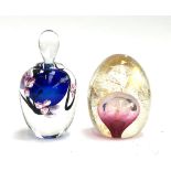 A hand blown paperweight by Roger Gandelman, blue with pink flowers, signed and dated 1988;