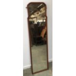 A shaped long mirror, mahogany frame, 157x42cm