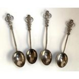 Four white metal Arts and Crafts style teaspoons