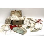 A miniatured domes chest containing a quantity of Victorian and later dolls clothes, to include