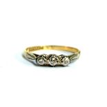 An 18ct gold and diamond three stone ring, size K 1/2, 1.7g