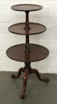 A George III mahogany three tier dumbwaiter, on cabriole legs with pointed feet, 56cmD 108cmH