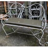 A metal garden bench with cushioned seat, 112cmL