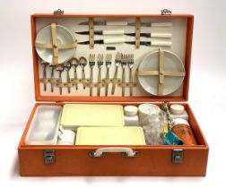 A Sirram mid-century orange picnic case, with contents