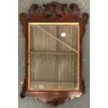 An 18th century style mahogany and inlaid fret carved wall mirror, 66x43cm