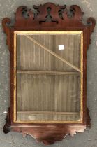 An 18th century style mahogany and inlaid fret carved wall mirror, 66x43cm