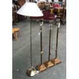 A trio of gilt metal and glass standard lamps; and one other (4)