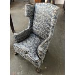 A good wingback mahogany framed armchair, with close nailed upholstery, feather filled cushion, on