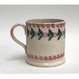 A 19th Century spongeware Tankard with red & green floral decoration, 11cmH