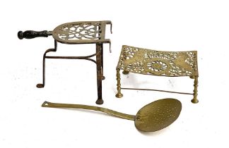 A brass and iron three legged trivet, with treen handle, 26cmH; further pierced brass trivet