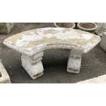 A curved composite stone bench