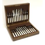 A Mappin & Webb oak cased canteed on mother of pearl, plated, and stainless fruit knives and forks