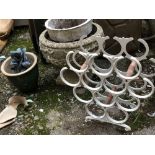 A white metal painted bottle rack, with several planters