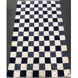 A blue and cream check rug, 244x148cm