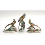 A porcelain parrot, heightened in gilt with encrusted floral detail to base, with Chelsea style gold