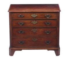 A George III mahogany chest of four graduating drawers, flanked by reeded canted corners, on bracket