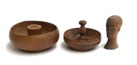 Two turned wooden nut bowls, one with band of inlay, 18 and 23cmD; together with a hardwood carved