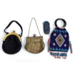 Four vintage early 20th century bags and purses to include a cut steel bead purse, beaded bag with