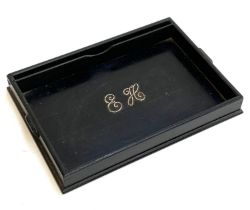 An early 20th century ebony desk tray, with single divider, and white metal monogrammed initials '