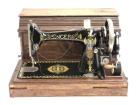 A Singer sewing machine serial number V982876 in oak case with key