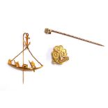 A 9ct gold Girl Guides brooch, 1.5g; together with a yellow metal stick pin with dangling boat, 1.