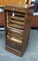 An oak tambour fronted filing cabinet with nine slides, with key, 46x43x111cmH